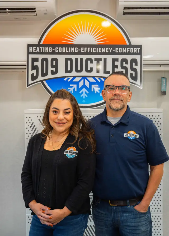 Javier and Lorena Perez, owners of 509 Ductless, standing in front of the 509 roundel